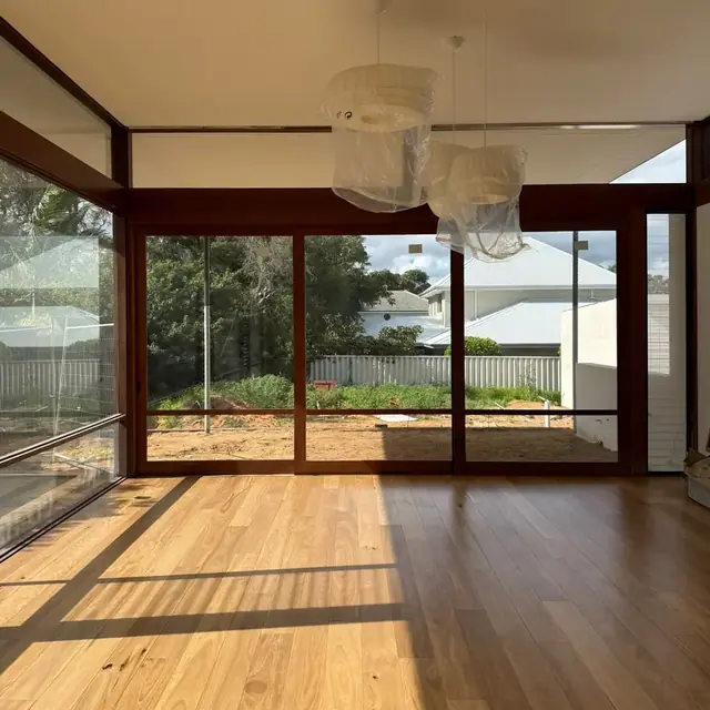 Timber flooring running to full-height glazing in a Perth home