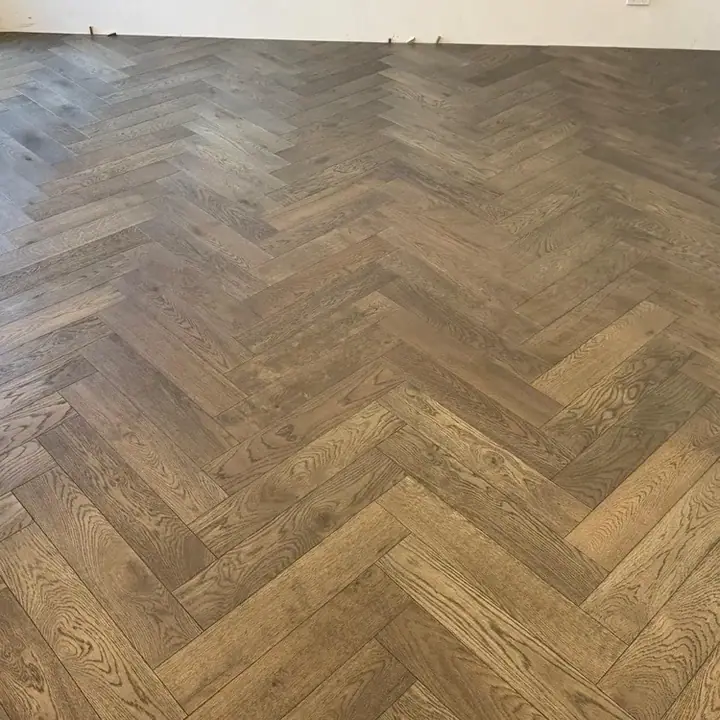 Living room after — smoked oak herringbone flooring installed