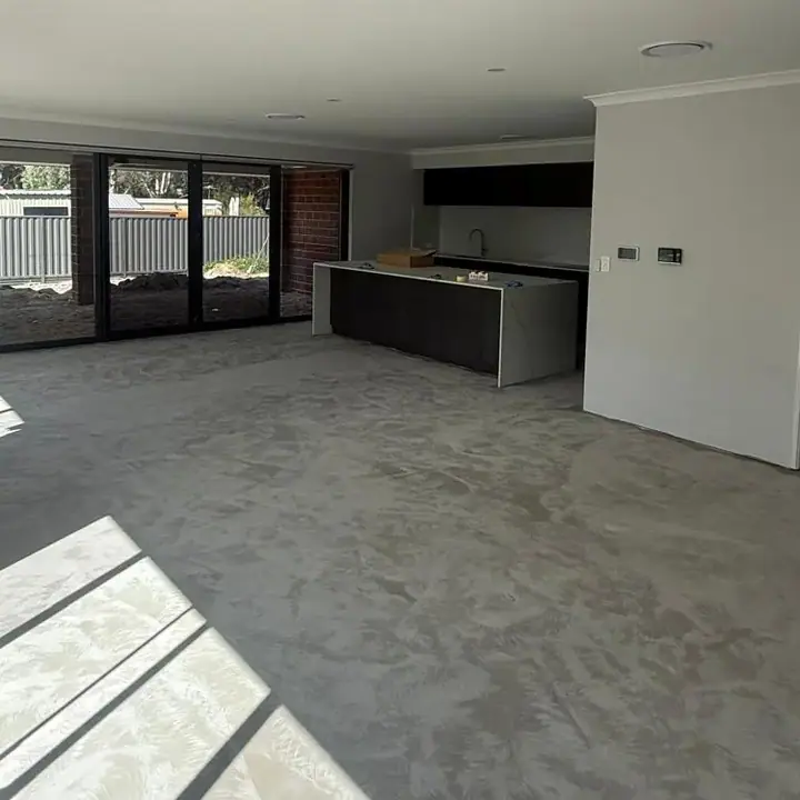 Living area before — bare concrete subfloor
