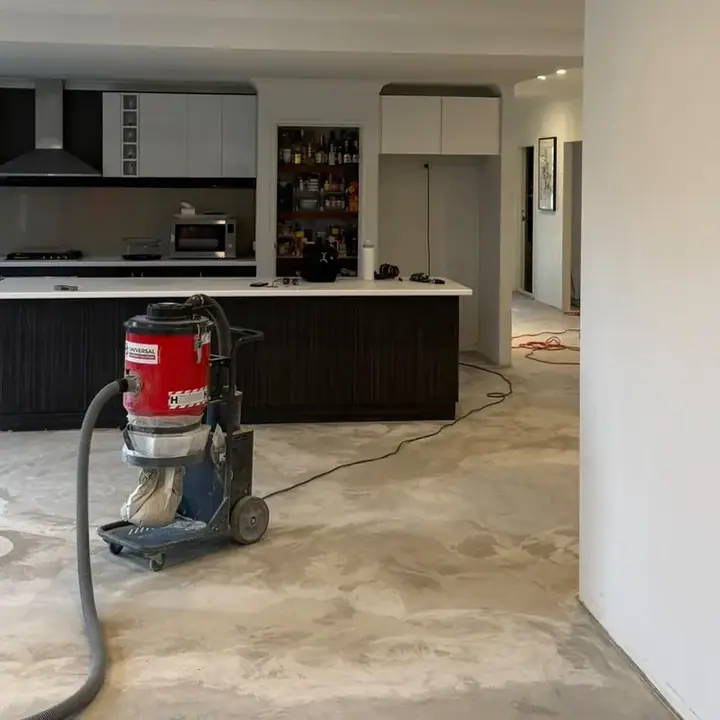 Open plan kitchen and living before — bare subfloor stripped and vacuumed