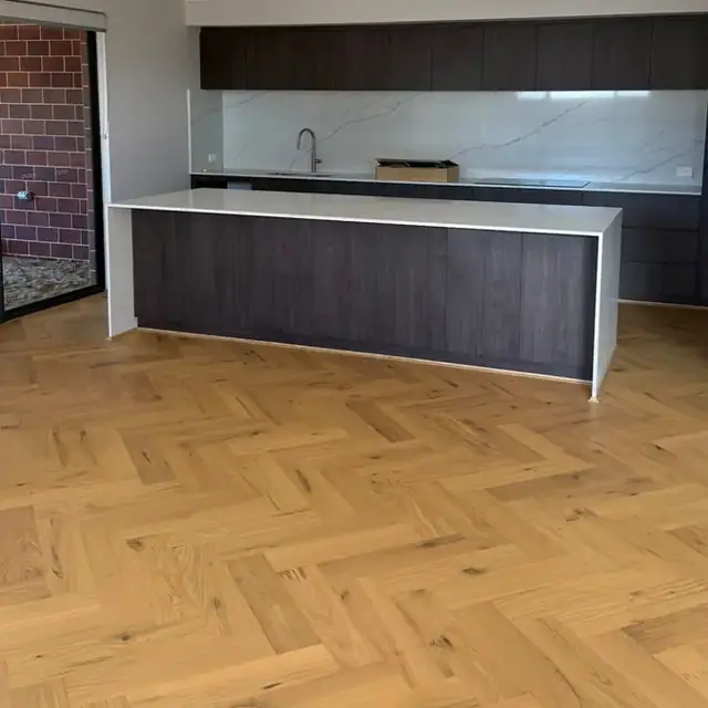 Herringbone flooring through an open-plan Perth kitchen and living area