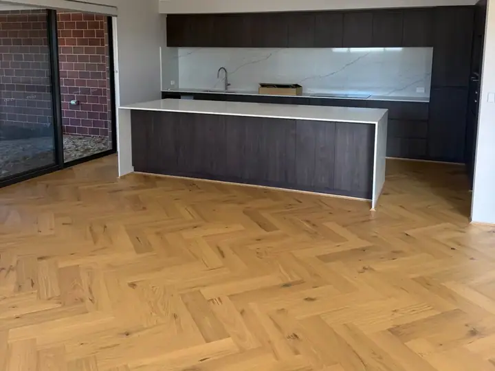 Herringbone flooring through an open-plan Perth kitchen and living area