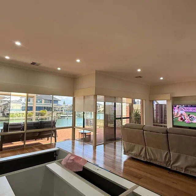 Timber flooring through an open living area overlooking the water
