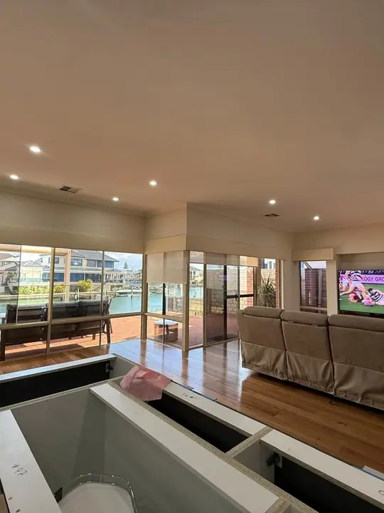 Timber flooring through an open living area overlooking the water