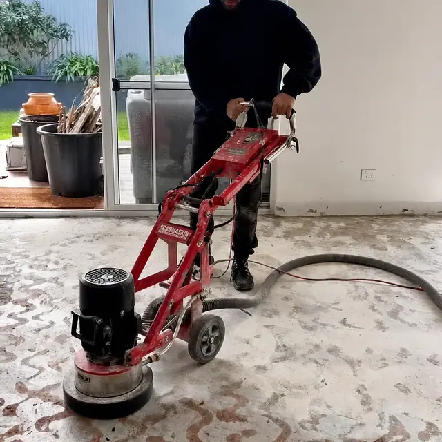 Concrete slab being ground back before the new flooring is laid