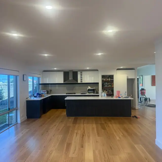 Engineered blackbutt flooring laid through the open-plan living and kitchen of a Butler home