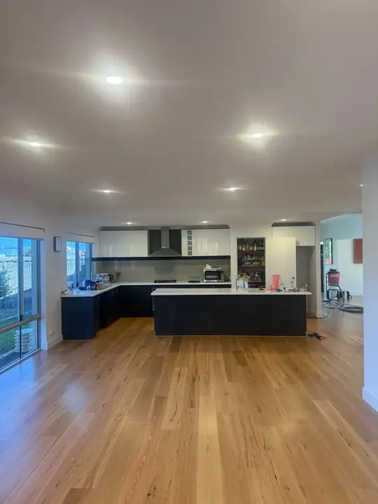 Engineered blackbutt flooring laid through the open-plan living and kitchen of a Butler home