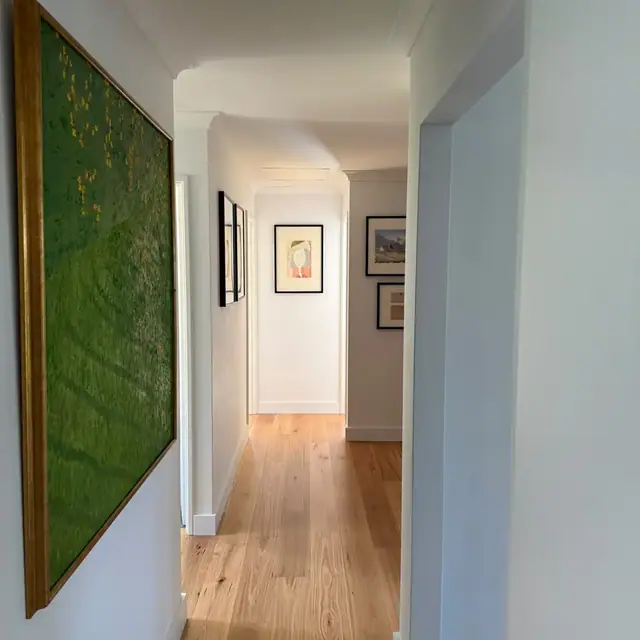 Engineered timber flooring running down a hallway past a feature artwork