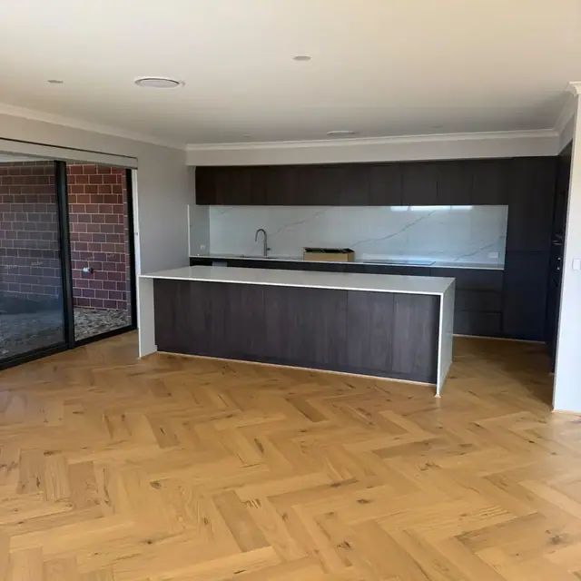 French herringbone oak flooring through a Perth kitchen and dining area