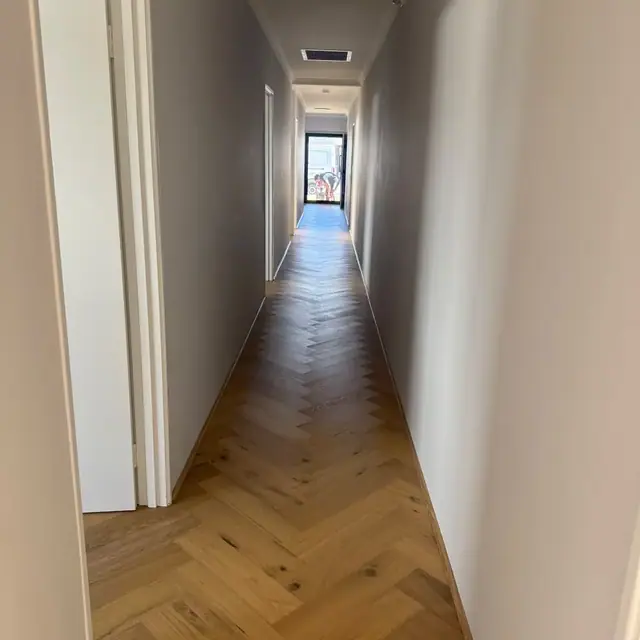 Herringbone parquetry flooring laid down a Perth hallway