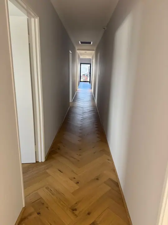 Herringbone parquetry flooring laid down a Perth hallway
