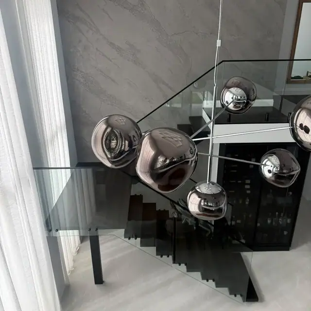 Dark timber staircase and glass balustrade viewed from above