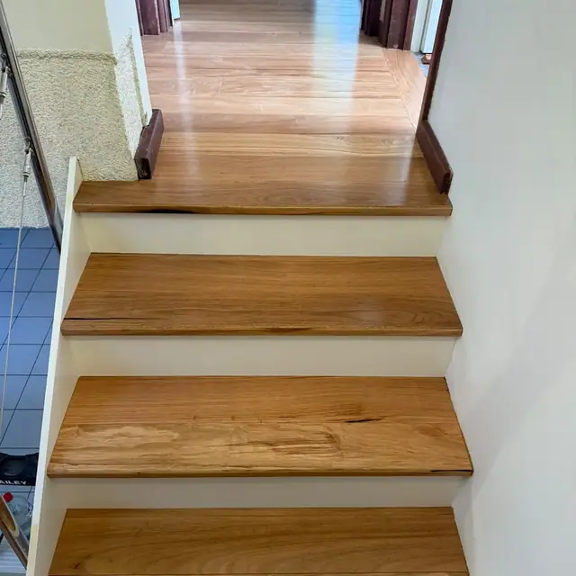 Timber treads and white risers on a modern staircase