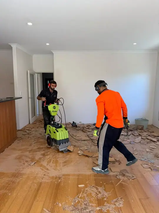 Nulook crew lifting an old floor with a stripping machine