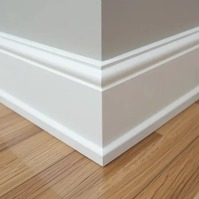 Mitred skirting board detail meeting a timber floor