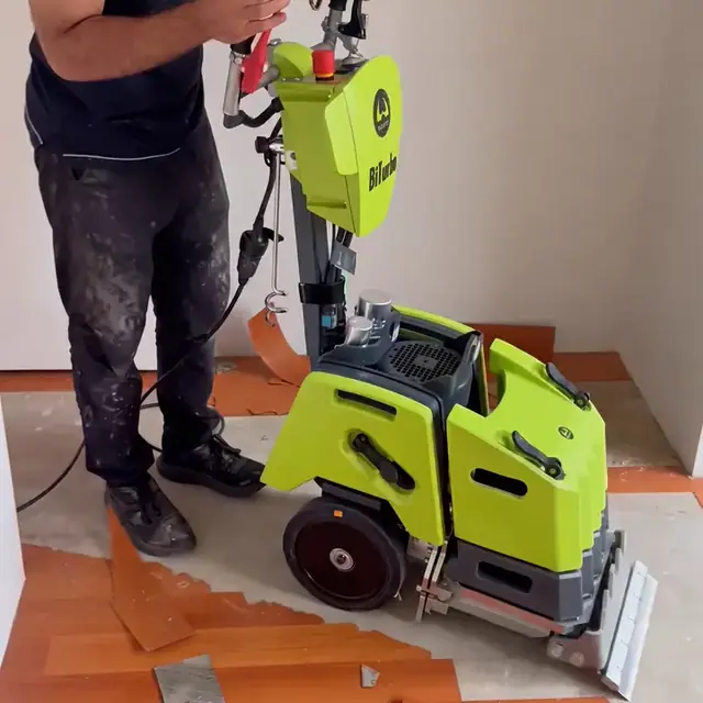 Nulook crew stripping out an old timber floor with a floor stripping machine