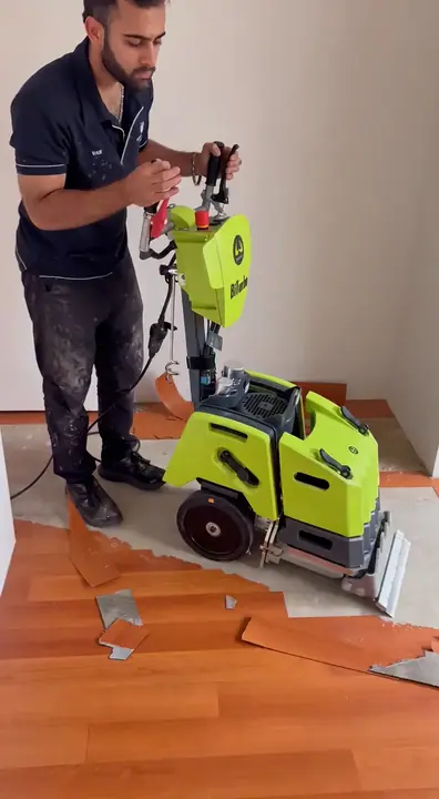 Nulook crew stripping out an old timber floor with a floor stripping machine