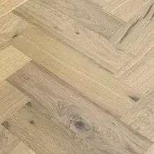 Close-up of light oak herringbone boards showing the grain
