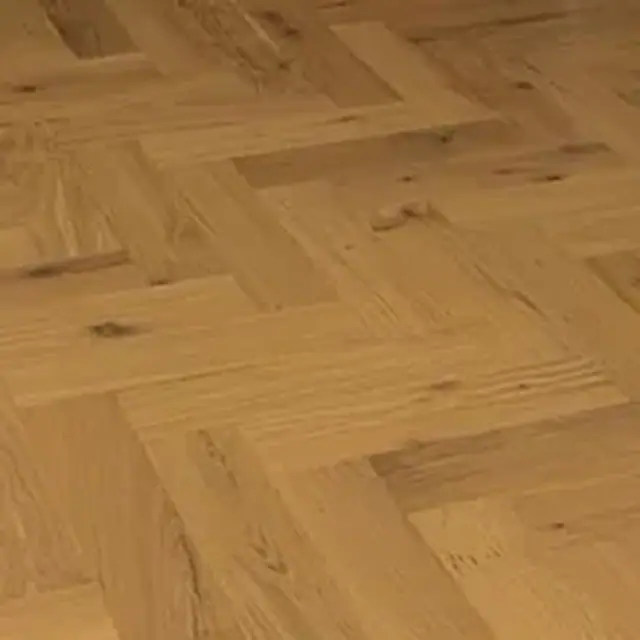 Close-up of oak herringbone parquetry showing the joins